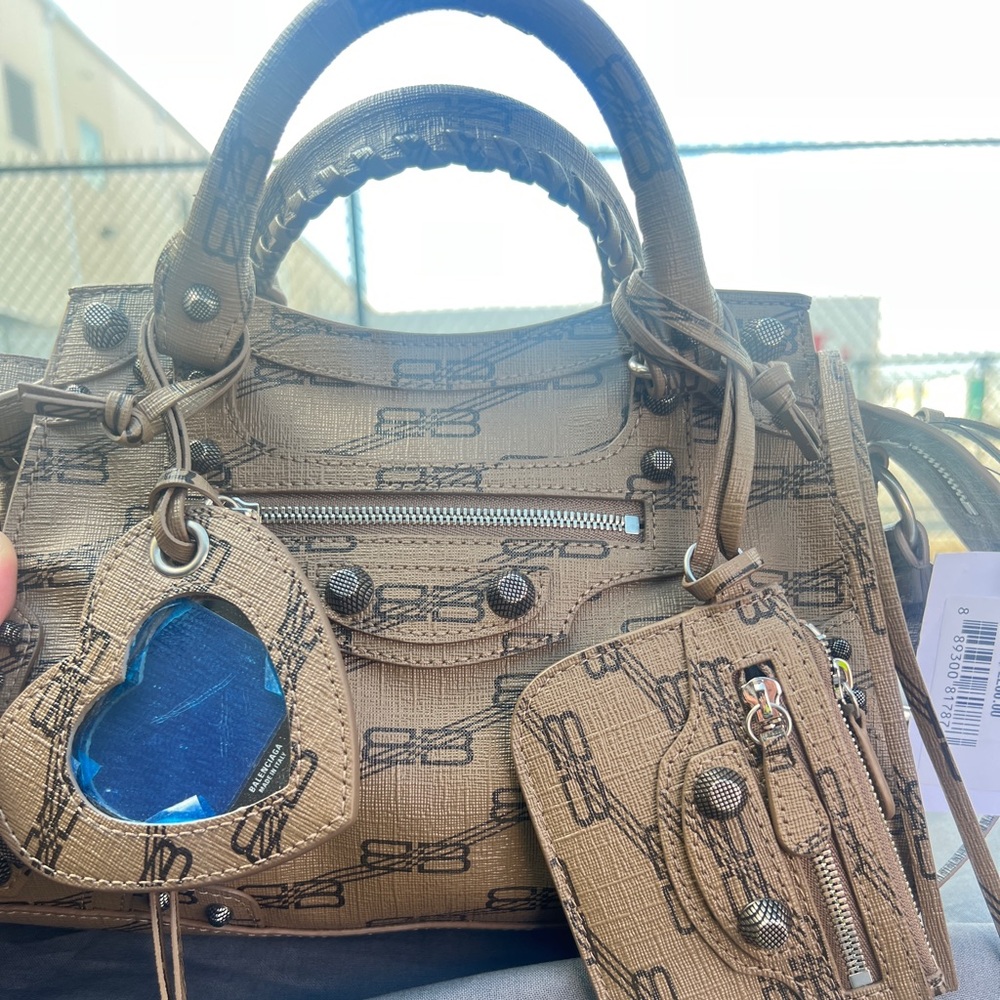 BALENCIAGA
Coated Canvas BB Monogram Neo Cagole XS Brown
